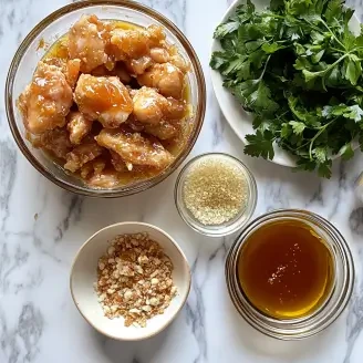 Chicken marinating in buttermilk with seasonings, an optional step for extra flavor in Baked Crunchy Hot Honey Chicken.